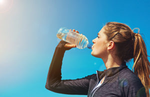 Summer Hydration Check Shot of a sporty young woman drinking water outdoors