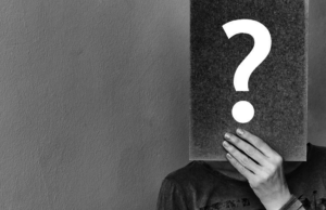 Good Question March/April 2019 man holding up board with a question mark on it