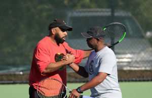 League News: Beat The Heat ALTA men's league players congratulating each other after a winning point.