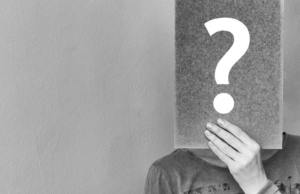 Good Question Sept/Oct 2019 man holding chalkboard with question mark on it