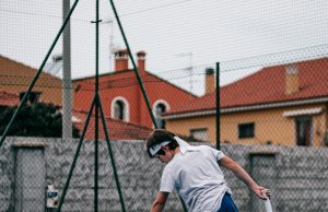 Improve Your Tennis With Better Serve Mechanics Man about to serve on a tennis court