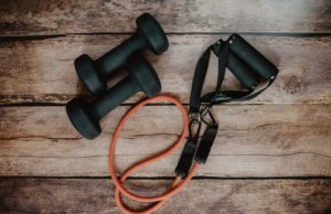 What Areas Should Be Trained To Be A Better Tennis Player? a set of small dumbbells and a fitness band.