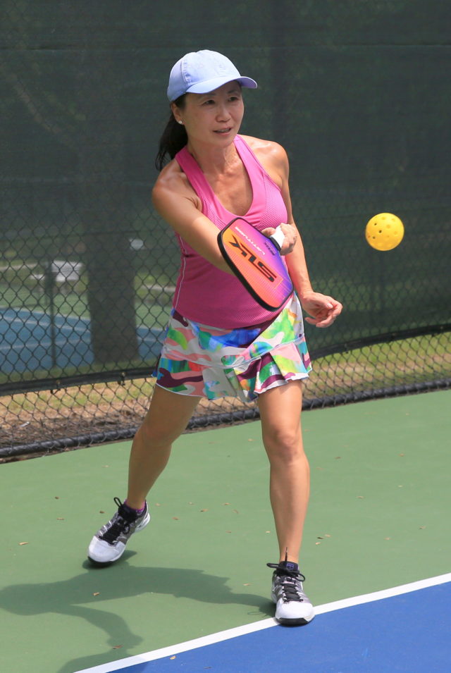 Female pickleball player on outdoor court