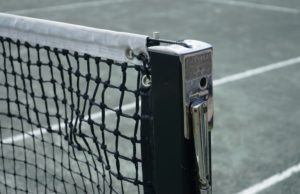 Good Question Mar/Apr 2023 Close-up of net on green clay tennis court