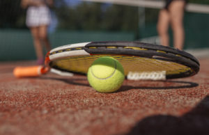 Mastering The Upgrade Tennis ball and racket on a clay court.
