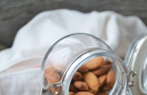 Cinnamon + Almond Clusters almonds spilling out of a glass jar