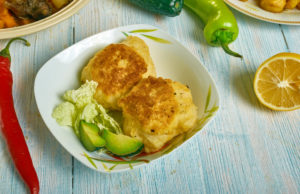 “Stamp + Go” Jamaican Saltfish Fritters Saltfish fritters with mango chutney, Caribbean cuisine, Traditional assorted dishes, Top view.