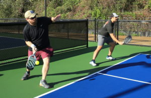 Pickleball Is Right At Home At ITA Two male players on a pickleball court