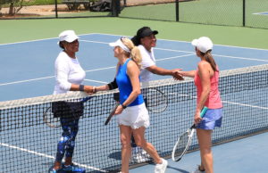 League News: Time For A Heart Check ALTA Senior Day League women's doubles players shaking hands at the net.