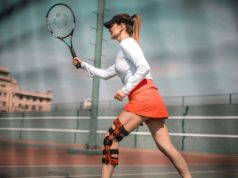 Preventing Injuries Woman with knee brace playing tennis