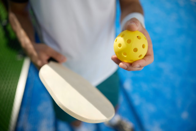 Close up of athletic man playing pickleball.