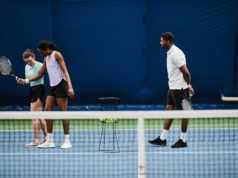 Four Easy Tips to Improve Your Practice and Match Play Performance Full length portrait of female tennis coach working with young African American woman during practice at indoor court