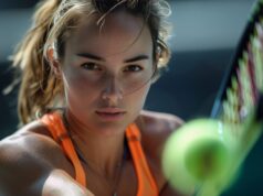 Learning To Play Better Under Pressure A young woman with a tennis racket in hand, poised for a match on the court.
