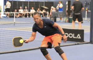 In A Pickle? The Big Swing Pickleball player hitting the ball.