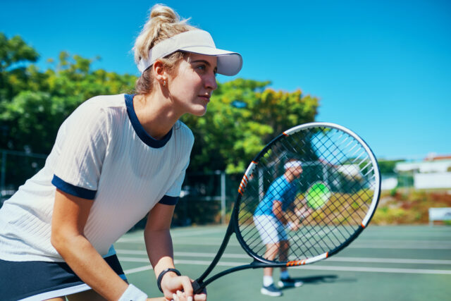 Mixed doubles team waiting to receive a serve.