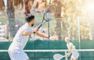 Sport Nutrition Preparation For Summer Tournament Play Tennis, man and woman training for fitness as a couple outdoors in a game or practice match in summ.