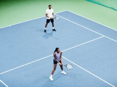 Doubles Communication Minimal high angle shot of African American couple playing tennis in pair at indoor court, copy space