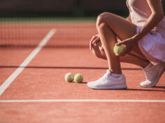 Captains’ Corner: Who’s Ready For Fall Tennis? Cropped image of girl holding a tennis ball while playing tennis on court outdoors