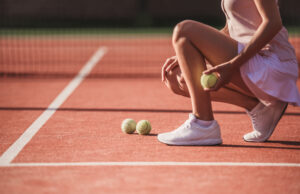 Captains’ Corner: Who’s Ready For Fall Tennis? Cropped image of girl holding a tennis ball while playing tennis on court outdoors